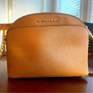 Michael Kors cognac crossbody with gold hardware and chain detailing on strap